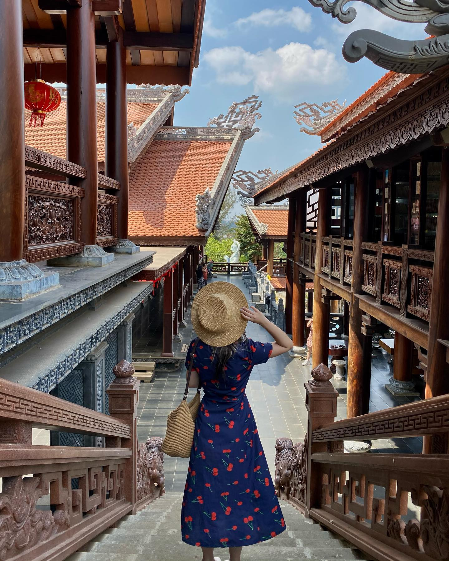 Hình ảnh du khách mặc đồ thanh lịch tạo dáng bên ngoài khuôn viên chùa